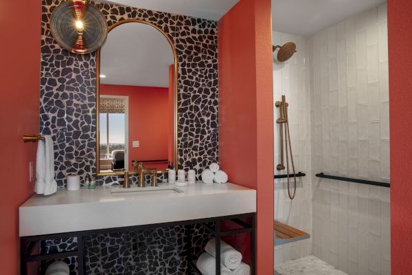 A stylish bathroom with a unique tiled archway and modern fixtures.