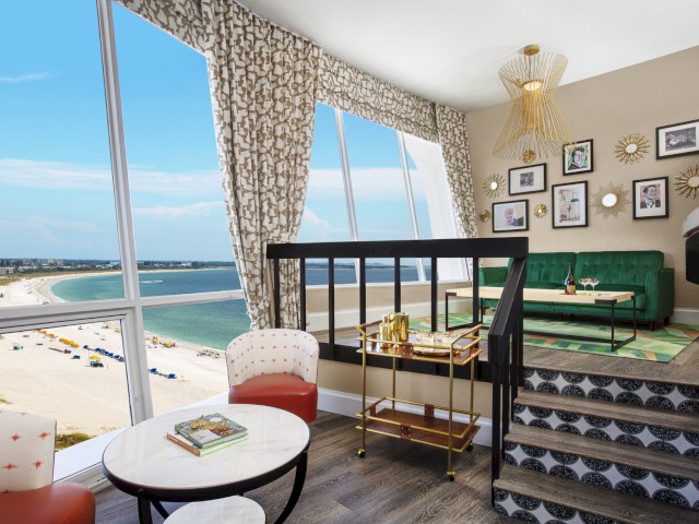 Elegant room with a beach view, stylish furniture, and decorative walls.