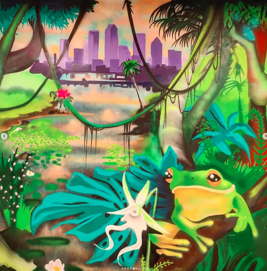 A colorful mural showcases a frog in a vibrant jungle scene with a cityscape in the background, combining nature and urban elements.