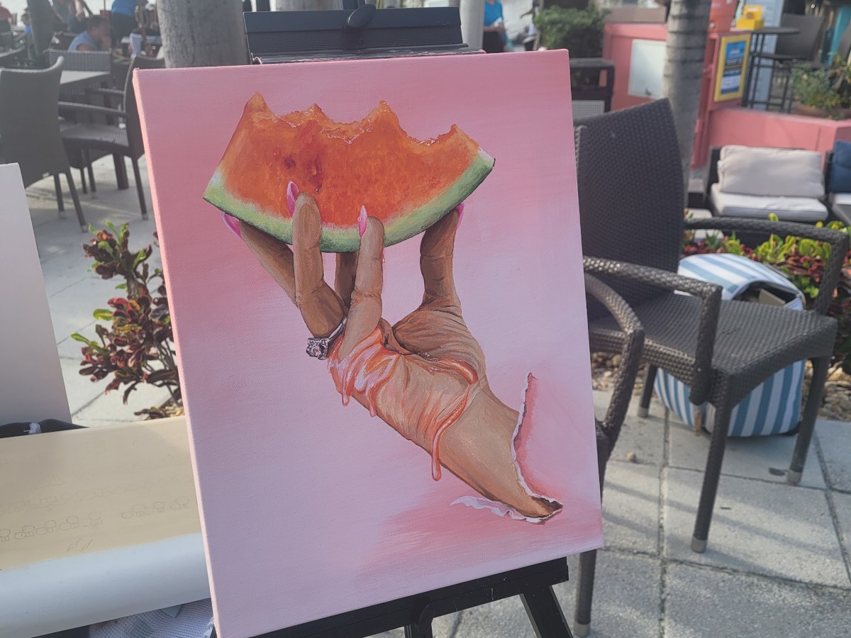 Painting of a hand holding a juicy watermelon slice.